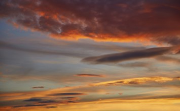 Sunset sky orange clouds over blue background