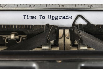 A vintage typewriter with the text time to upgrade