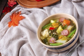 Delicious autumn vegetable soup with sausage and bacon