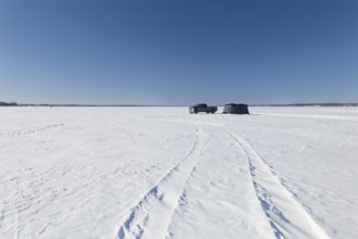 Winter, truck next to a icefishing tent on the frozen Saint Lawrence River, Province of Quebec,