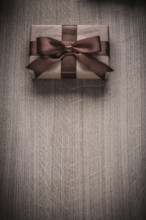 Wrapped vintage giftbox with brown ribbon celebration concept