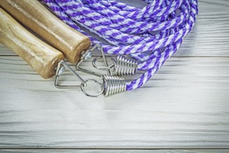 Rolled jump rope on wooden board sports training concept