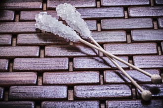 Sweet sugar sticks on wooden matting food and drink concept