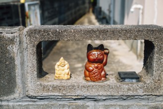 Japanese lucky cat maneki neko at Japanese old village Uchiko town in Ehime, Shikoku, Japan, Asia