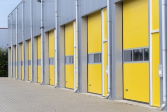 Exterior of a commercial warehouse with yellow roller doors
