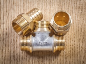 Plumbing fixtures on wooden board