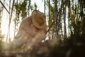 Beautiful Woman with her head down in forest
