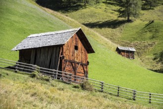 An old wooden hay shed in Val di Morins, the Dolomite Alps of South Tirol