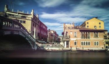 Ancient buildings and boats in the channel in Venice
