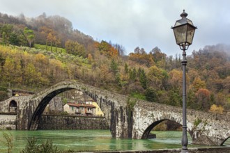 Picturesque stone Devil's Bridge over the Serchio River. Medieval bridge of magnificent