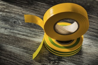 Yellow insulation tape on wooden board