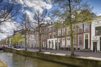 View of Delft canal with historic houses, Netherlands