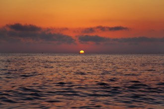 Mediterranean sea sunrise sunset with sun in red sky