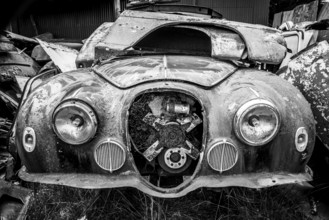 Antique cars on a big scrapyard at the end of Old Coach Road Trail, North Island of New Zealand
