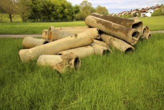 Dismantled concrete pipes in a meadow