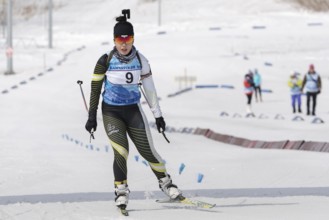 Korean sportswoman biathlete skiing at finish after rifle shooting. Lee Hyunju South Korea during