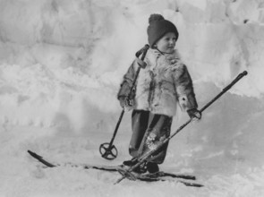 King Harald of Norway. Pictured when being crown prince and a young boy on skis on a winter day.
