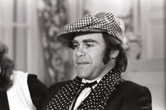 Elton John. English singer, songwriter born march 25 1947. Pictured wearing a chequered cap and a