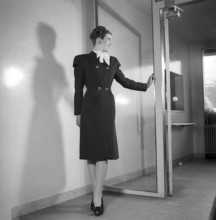 Women's fashion in the 1940s. A young woman in a typical 1940s coat. Photographed in full figure