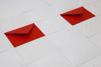Composition with white and red envelopes on the table