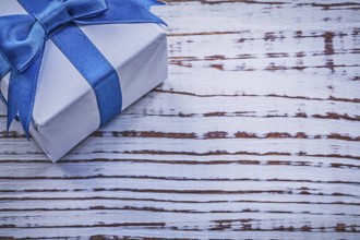 Present box on vintage wooden board greeting card holidays concept