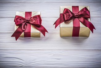 Wrapped giftboxes on wooden board directly above holidays concept
