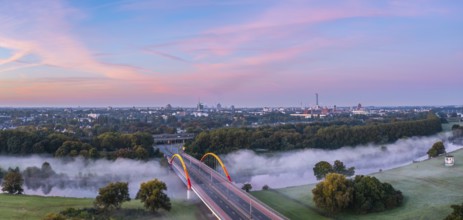 Sunrise and the first rays of sunshine over the fog-covered Ruhr meadows in Duisburg, Germany,