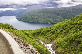 Magnificent panorama of the fjord. Norway. Traveling by camper on road 520. The road is fenced with