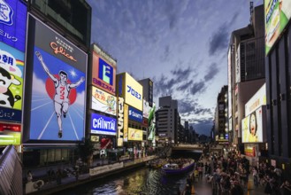 OSAKA, JAPAN - SEPTEMBER 24 2024: The view down Dotonbori River from Ebisubashi Bridge on a clear