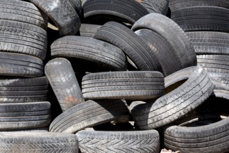 Old and used car tyres on a pile