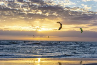 Kite surfing on the sea in the sunset