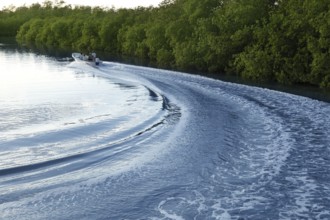 Boat ship wake prop wash curve on sunset lake river