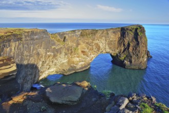 The cape Dirkholaey in the south of Iceland. The enormous rock elephant it is lit with a summer.