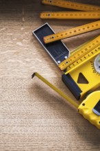 Oak board with wooden meter measuring tape construction level and square ruler construction concept
