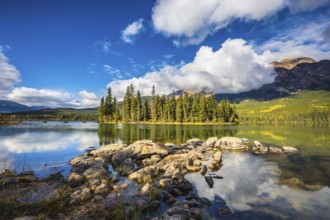The autumn morning in the Rocky Mountains of Canada. Charming little island in the Pyramid Mountain