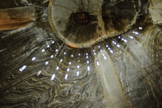 A view of the ceiling in the historic Salina Turda salt mine in Romania called owl's eyes