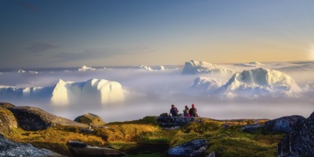 Sitting, picnic, relax by the sea with icebergs in the fog, in the haze