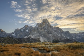 Cimon delle Pala mountain above Passo Rolle with white clouds