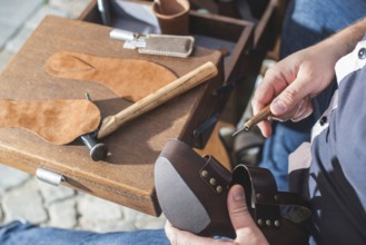 Hands making shoes. Shoemaker