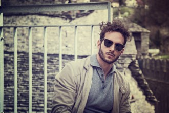Attractive man outdoor in old European castle, in Switzerland. Athletic build, with tight t-shirt