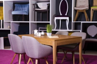 Shop, sale of furniture in a shopping centre. Exposure sample Dining wooden table with textile