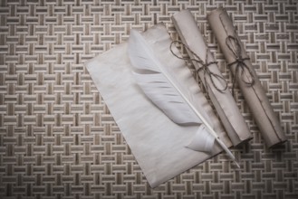 Rolls of vintage paper clean sheet quill on woven matting