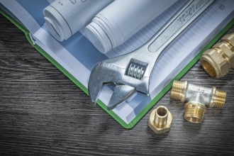 Adjustable spanner plumbing pipe connectors rolled construction plans notebook