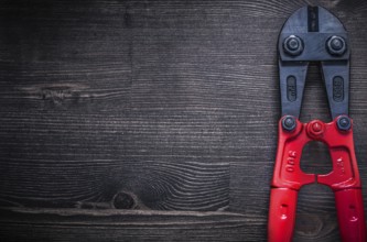 Metal steel cutter on wooden board copyspace construction concept