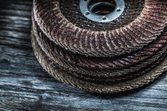 Pile of rotary abrasive discs on wooden board
