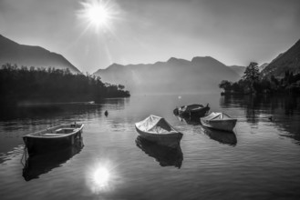 Amazing Lake Como panorama : sunny day in winter, Sheathed boats in water near coast, ducka