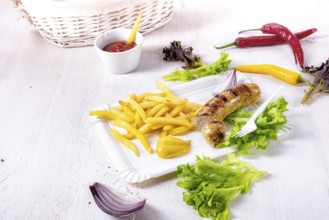 Delicious grilled bratwurst with fries and mustard