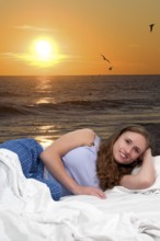 Beautiful young woman in bed at bedtime