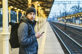 Sopot Fast Urban Railway station. young man standing and waiting train on platform. tourist travels