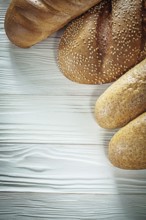 Brown bread baguette on white board